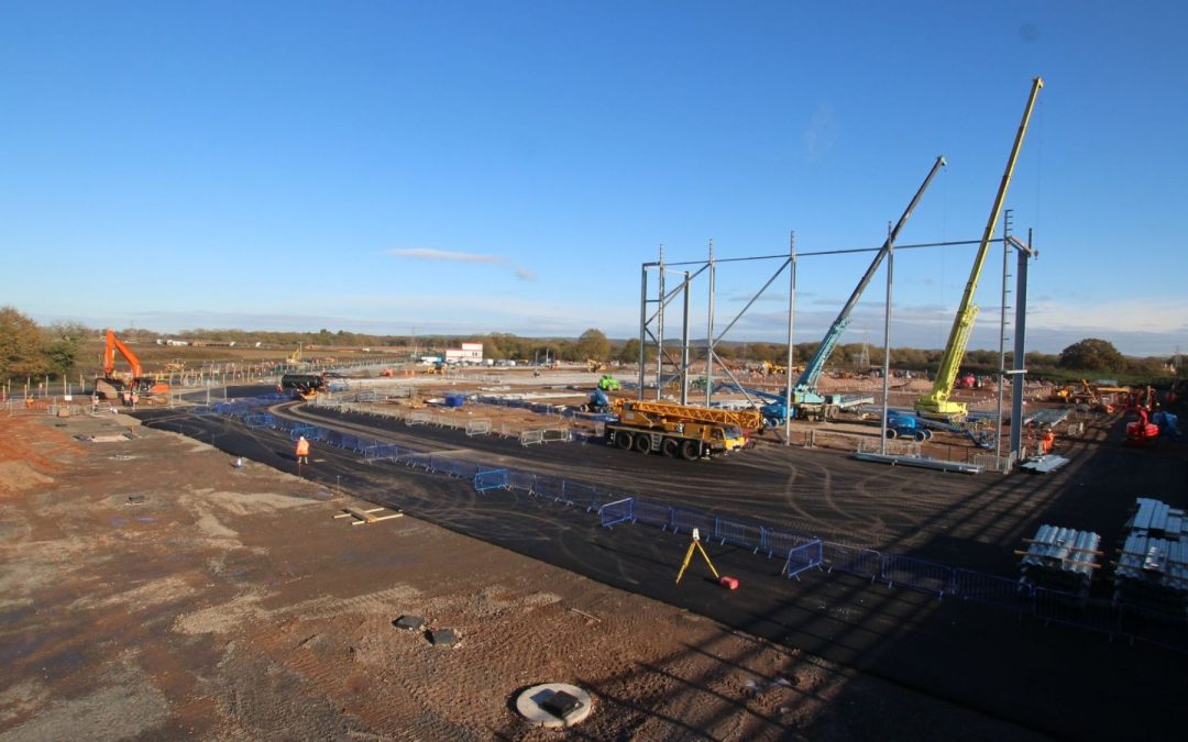 Construction cranes erecting the first steel frame at Unit 5030, West Midlands Interchange.